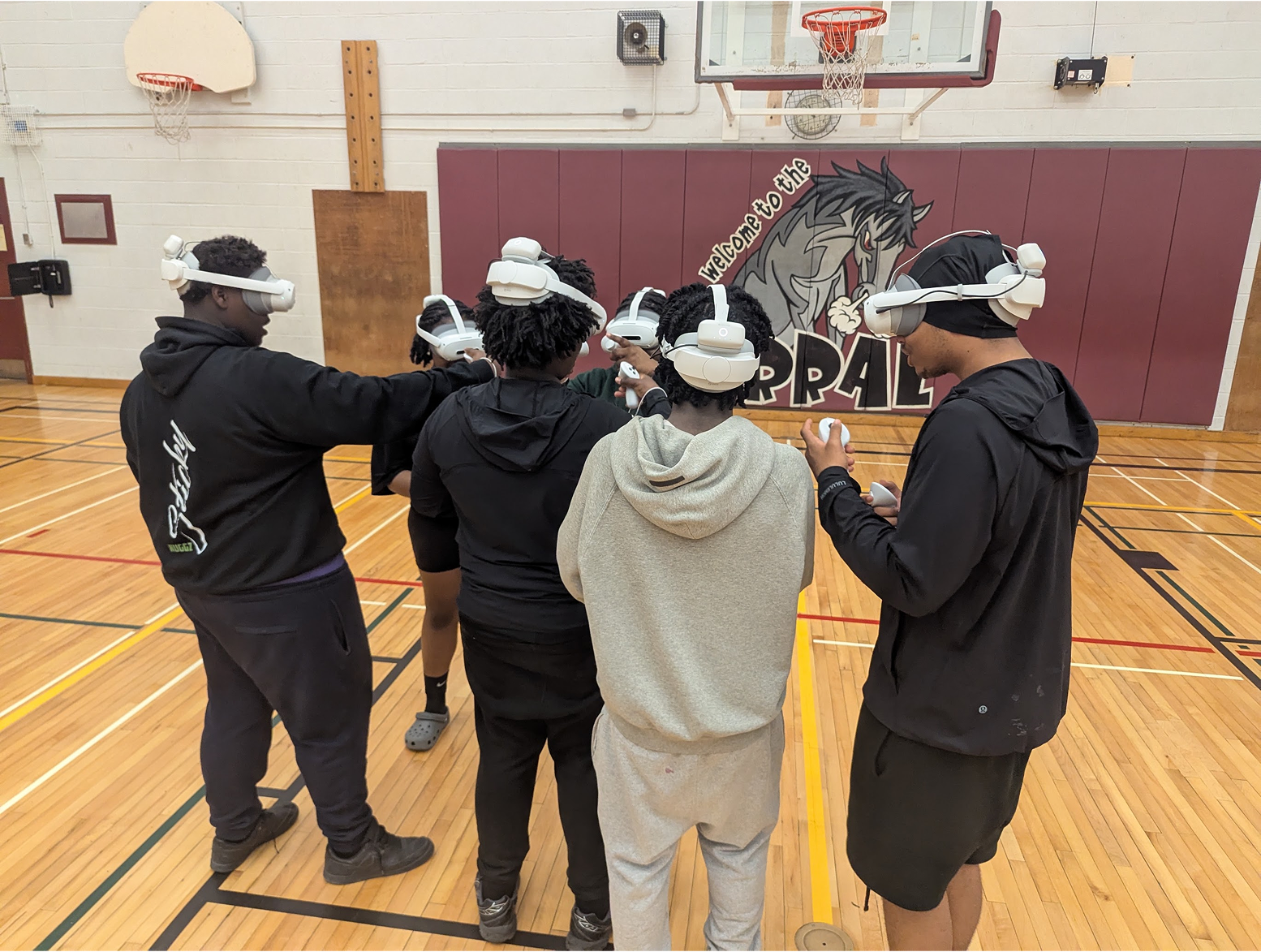 Students exploring a VR experience in a school gym